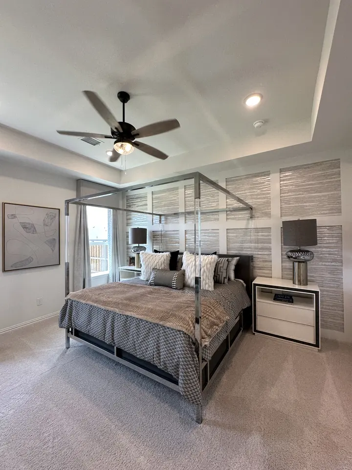 Bedroom with a tray ceiling, textured feature wall and new carpet