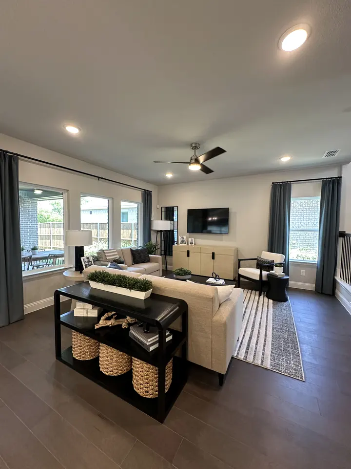 Living room with dark wood-look flooring and soft neutral walls